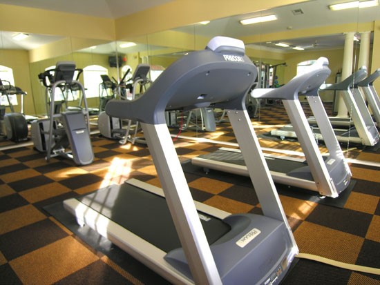 Champion Lake Apartments Fitness Room With 3 Treadmills, and Mirrors on The Wall